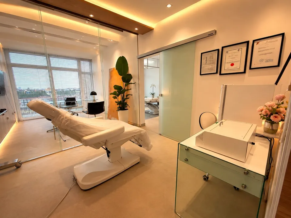 Treatment room at AS Clinic with a treatment chair and framed certificates on the wall